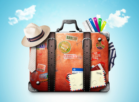 Retro suitcase of a traveler with travel stickersの写真素材