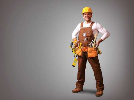 Builder in yellow helmet, protective glasses and working clothesの写真素材