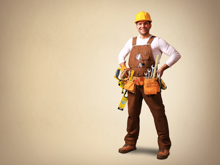 Builder in yellow helmet, protective glasses and working clothesの写真素材