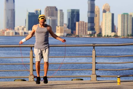 Morning exercises with skipping rope on the background of the cityの写真素材