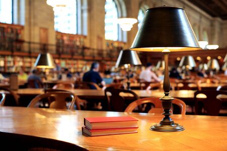 Books on the table in the reading room in the library