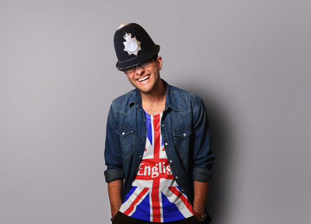Young man in a helmet of the British policemanの写真素材