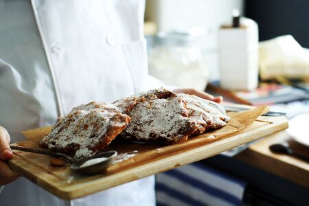 Almond croissants on a tray in a kitchen