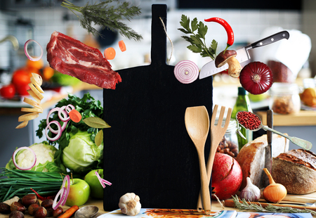 Kitchen a large black board with vegetables and breadの写真素材