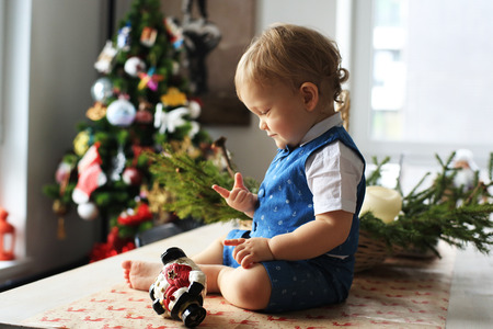 Little boy in suit on the background of Christmas tree