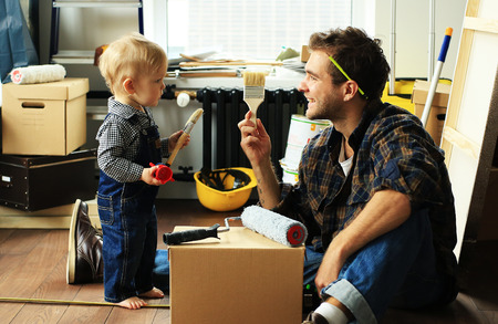 Father shows a paint brush of his little sonの写真素材