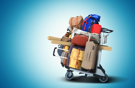 Airport cart with a bunch of bags and suitcasesの写真素材