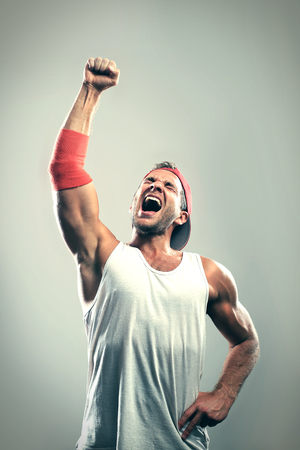 Athlete with a raised hand celebrates victoryの写真素材