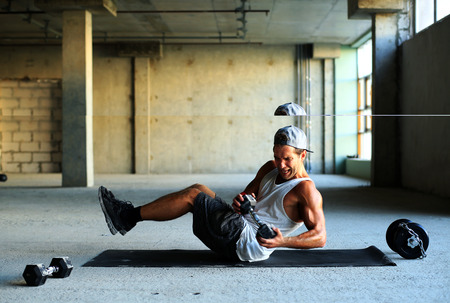 Athlete is engaged in crossfit in brutal gym