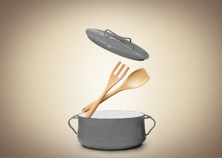 Big gray pot for soup with fork and spoonの写真素材