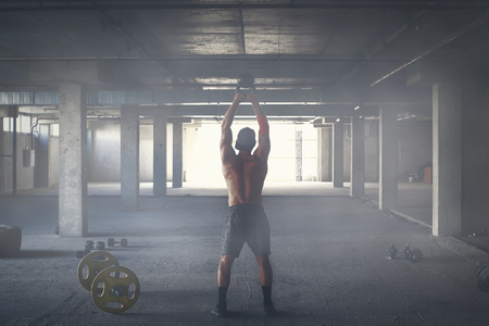 Athlete is engaged in crossfit in brutal gymの写真素材