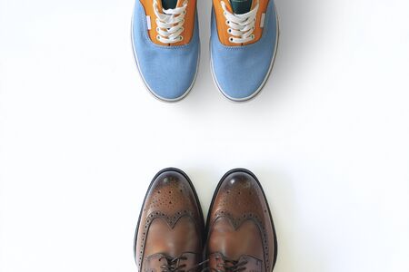 Colored men's sports sneakers and classic leather shoes on white backgroundの写真素材