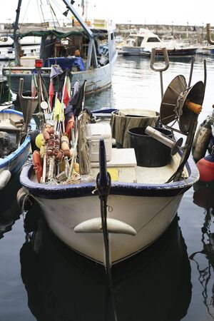 Old fishing boat with tackle in Italyの写真素材