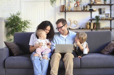 Young beautiful happy family relaxing at homeの写真素材