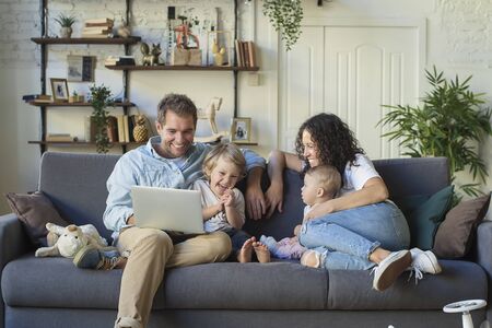Young beautiful happy family relaxing at homeの写真素材