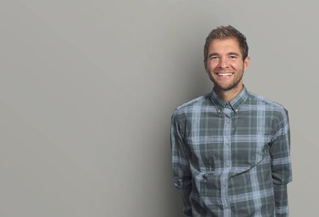 Young man in denim shirt is smiling