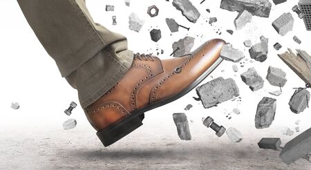 Man with a shoe smashing a wallの写真素材