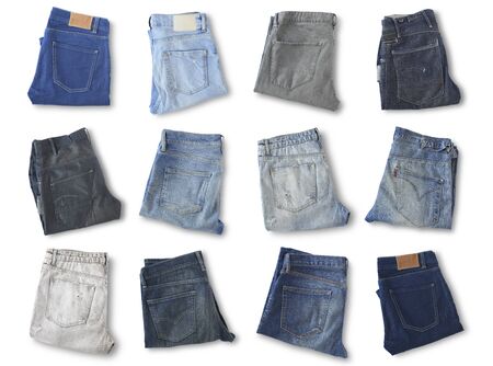 Different jeans lie on the light floorの写真素材