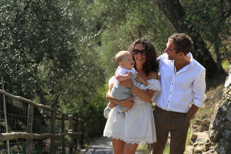 Young beautiful family walks in the Park in Italyの写真素材