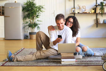 Young beautiful happy family relaxing at homeの写真素材