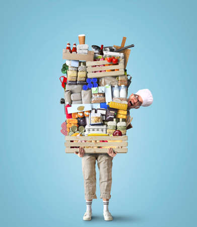 Cheerful chef keeps a huge pile of vegetables and other products