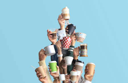 People are holding mugs and paper cups of coffee. Concept on the theme of cafes and coffee. Christmas tree.の写真素材