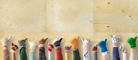 Hands up up in the different mittens. Winter concept.の写真素材