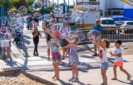 Gran Canaria, Spain - October 17, 2019:  Children playing with soap balloonsのeditorial素材