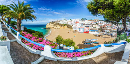 Carvoeiro town with colorful houses and yellow sand beach in Algarve, Portugalの写真素材