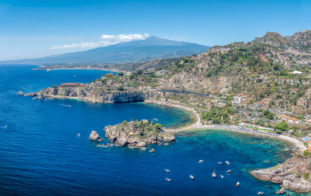 Landscape with beauty of Isola Bella in Taormina, Sicily, with its crystal-clear waters and stunning views of Mount Etna.の写真素材