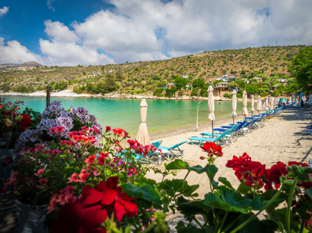 Landscape with sun umbrella and lounge chair on Aliki beach at Thassos islands, Greeceの写真素材