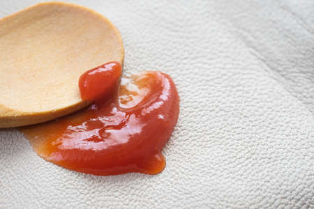 Ketchup stain on white leather texture, macro texture, cleaning conceptの写真素材