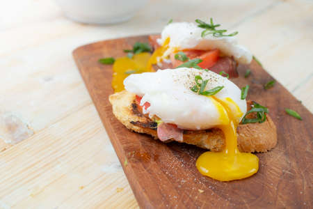 Sandwich with ham and Poached Egg. Wholemeal Bread Toast smoked ham and egg , healthy breakfast or snack. close upの写真素材