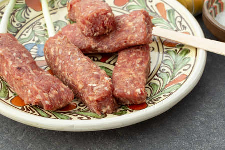 raw mici or mititei romanian traditional dish , close up on a ceramic plateの写真素材