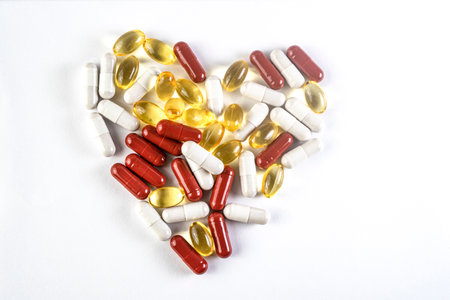 supplements, pills arranged to look like a heart, isolated on white