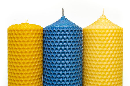 yellow and blue candles with honeycomb pattern , close upの写真素材