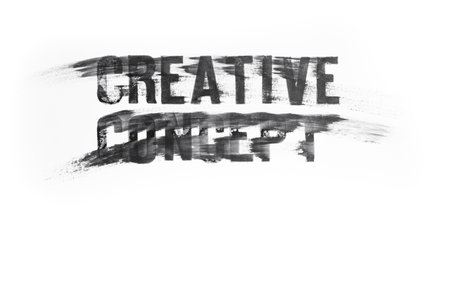 Creative concept words in capital letters written with black ink stamp letters, and smudged across white glossy paper. Close up textureの写真素材