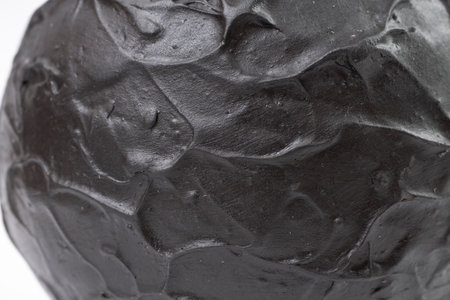 Black ceramic texture, soft focus close up