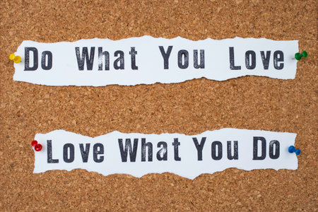 Do what you love, love what you do , written on white paper strips pinned on a corkboard. close upの写真素材