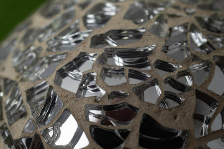 Disco ball made from irregular mirror shards, soft focus close up