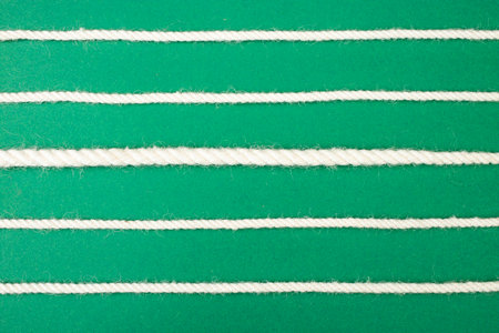 White cotton rope lines on green background, soft focus close upの写真素材