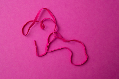 magenta elastic ribbon on magenta background, soft focus close up