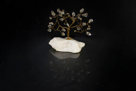 Copper wire tree on black background, close up with reflectionの写真素材