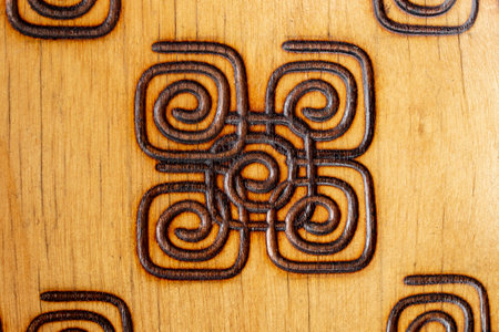 Square spirals made on wood with a Pyrography pen, abstract close up textureの写真素材