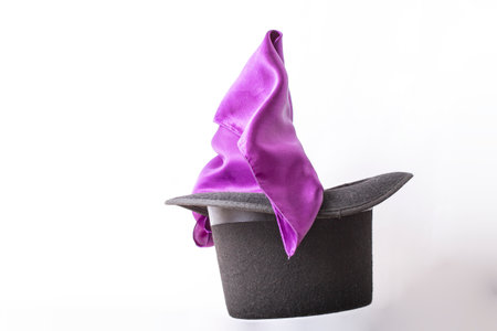 Silky fabric coming out of a tall hat, levitating on white backgroundの写真素材