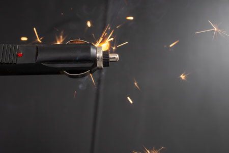Cigarette lighter charger plug burning with sparks in a car, close up, conceptの写真素材