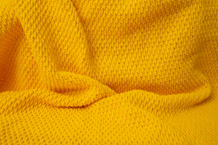 Crochet orange blanket, abstract backdrop, soft focus close upの写真素材