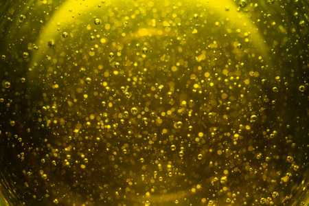 Green golden background with oil bubbles, soft focus abstract photography backdropの写真素材