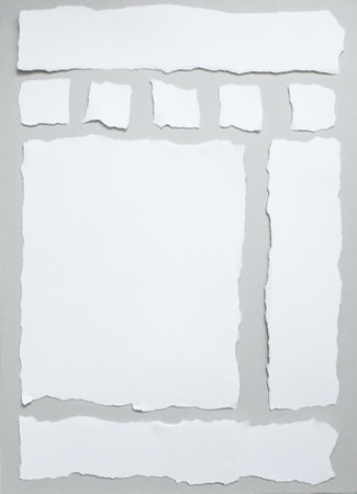 Ripped white paper strips on gray   background, arranged as webpageの写真素材