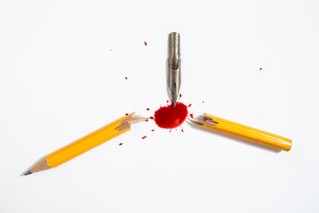 Steel pen nib snapping in half a wooden crayon and staining with blood like red ink the white...